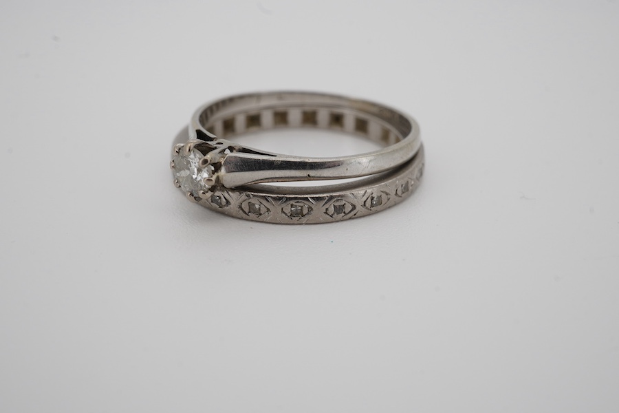 Two diamond rings, early 20th century, comprising: a solitaire ring set with an antique circular-cut diamond weighing approximately 0.15 carats, size O, stamped 18CT; and an eternity ring set with single-cut diamonds, si